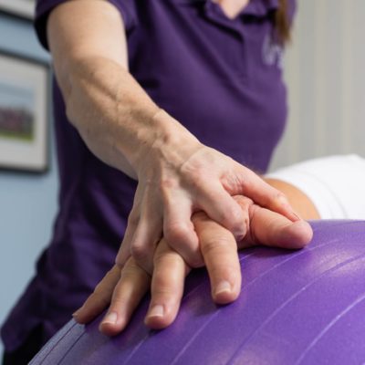 hands on a large exercise ball